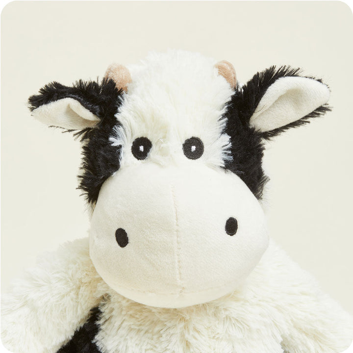 Warmies plush cow stuffed animal with black and white fur pattern and pink ears