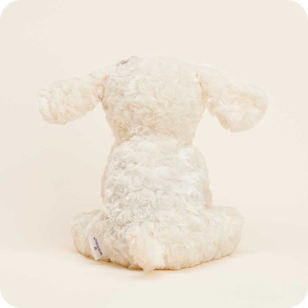 Warmies cream colored curly plush dog stuffed animal on clean white background