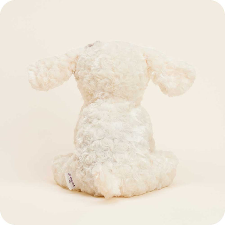 Warmies cream colored curly plush dog stuffed animal on clean white background