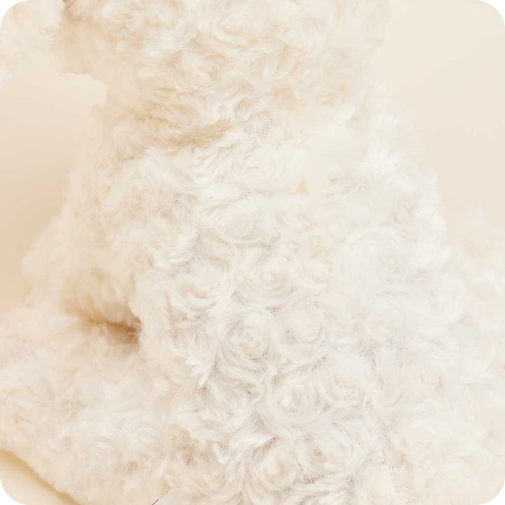 Warmies cream colored curly textured plush dog with patched fur design