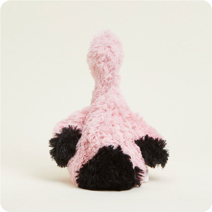 Pink fluffy Warmies plush toy flamingo with black beak and feet on white background