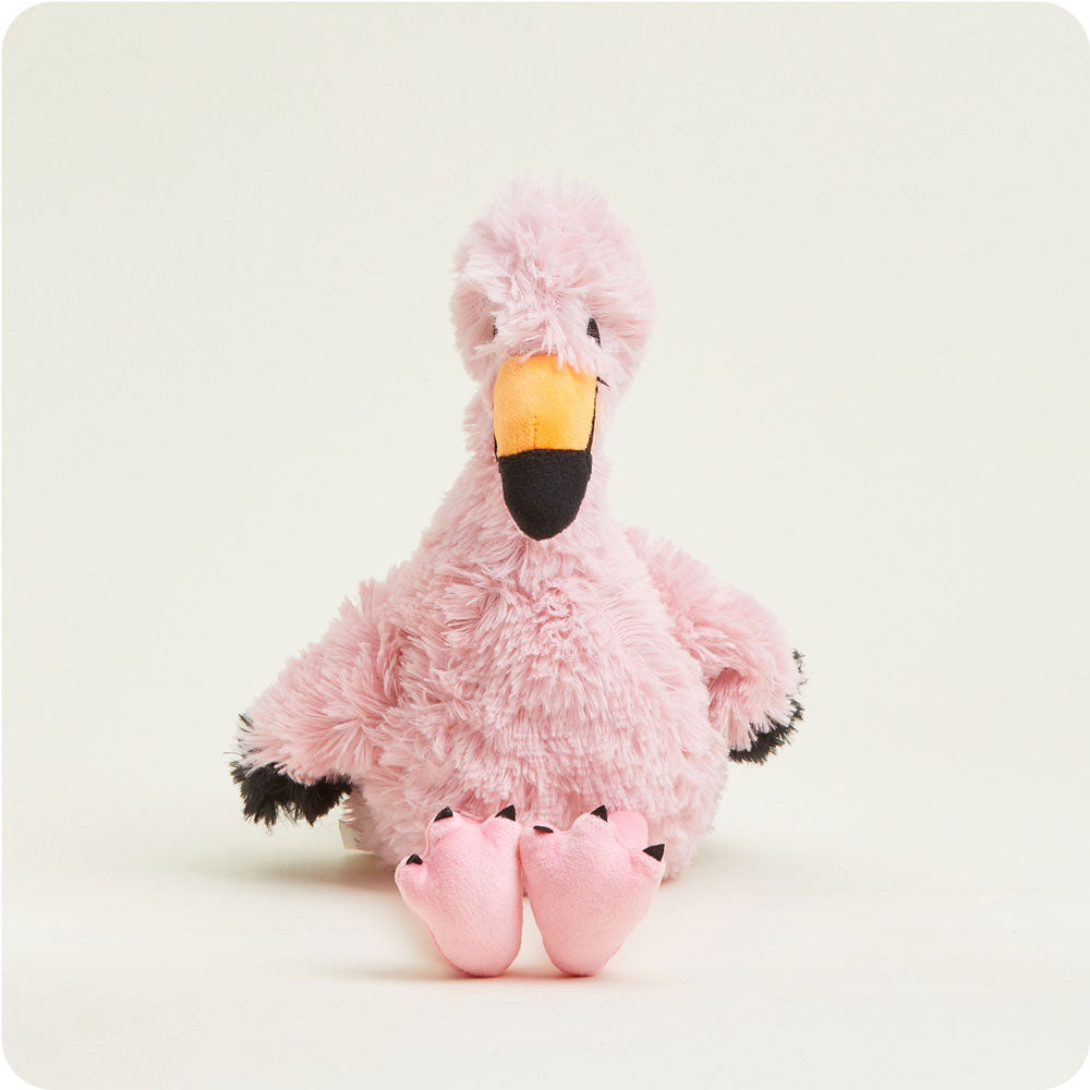 Pink flamingo Warmies plush toy with fluffy fur and orange beak on white background