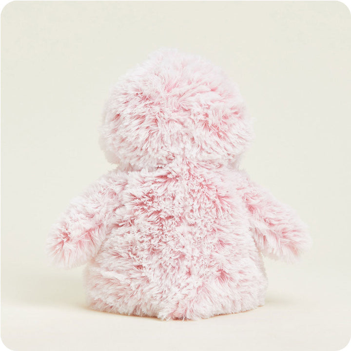 Pink fluffy Warmies penguin plush toy with soft fuzzy texture on white background