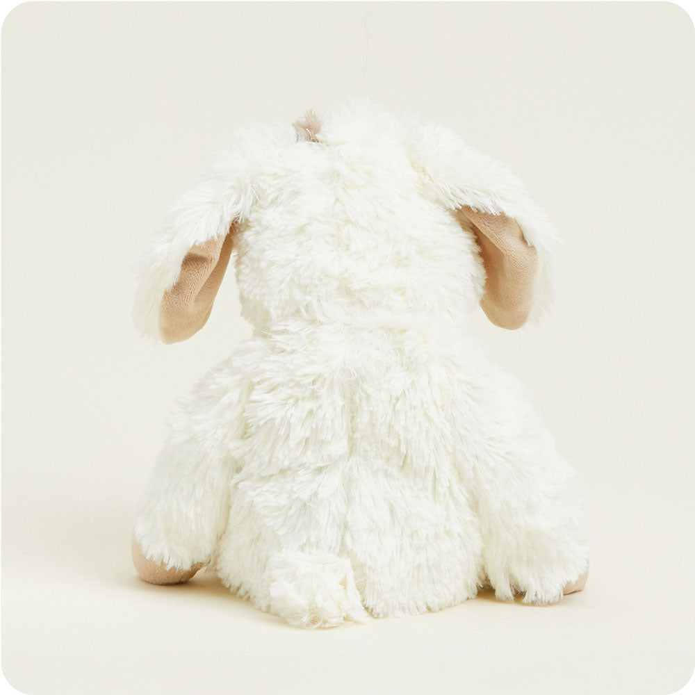 Warmies cream colored puppy plush toy with tan ears viewed from behind