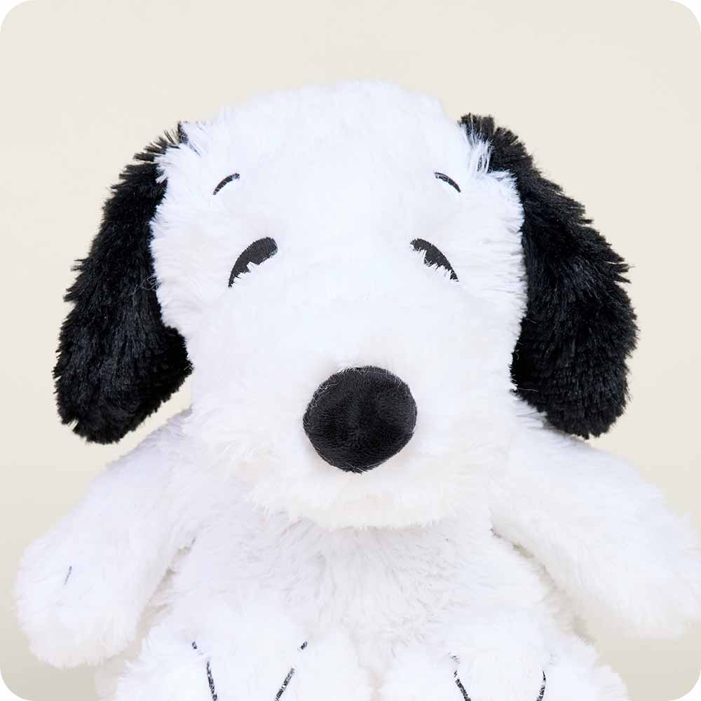 Warmies plush Snoopy dog with white body, black ears and nose on clean background