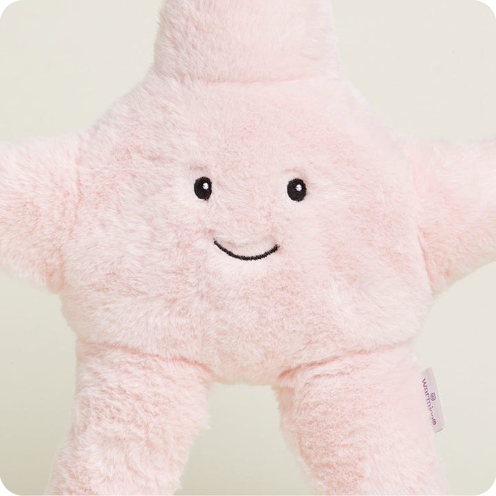 Pink starfish-shaped Warmies plush toy with embroidered smile and eyes