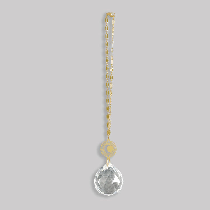 Scout Pocket Suncatcher with gold sun medallion and clear crystal drop pendant