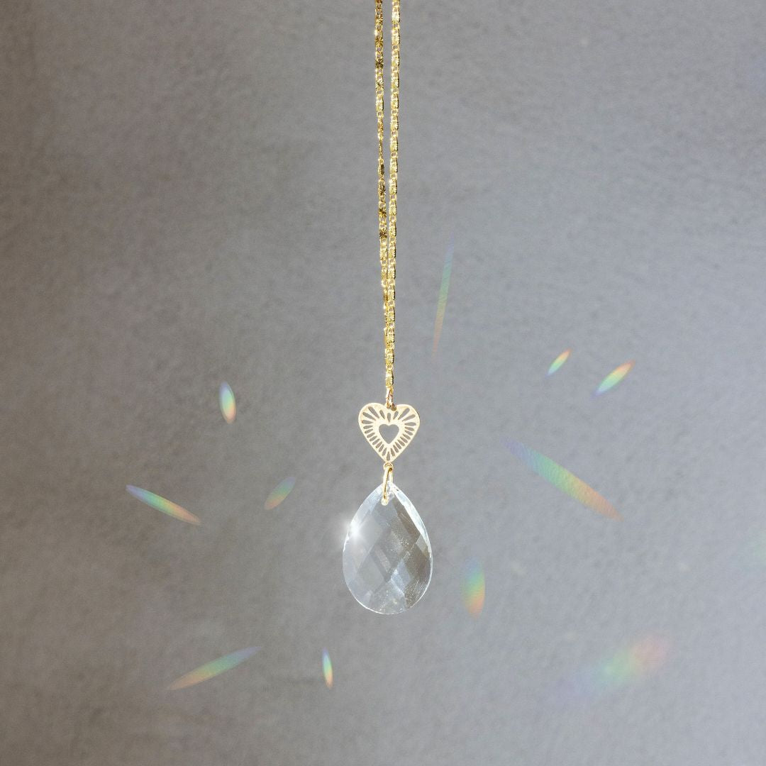 Scout Pocket Suncatcher with clear crystal teardrop and gold radiating heart charm on chain