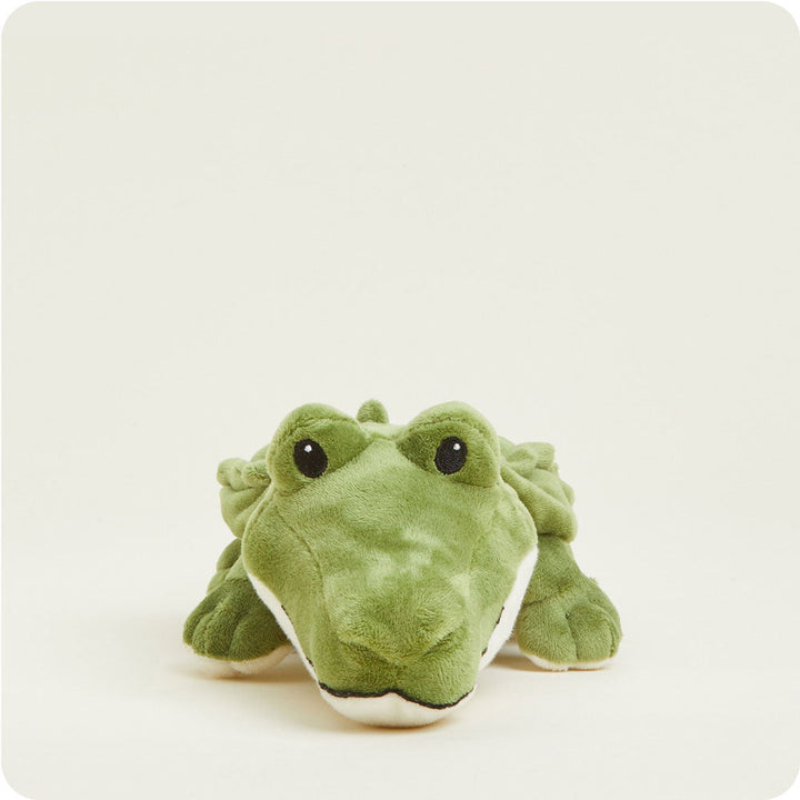 Green alligator plush toy Warmies Junior heating pad with black eyes