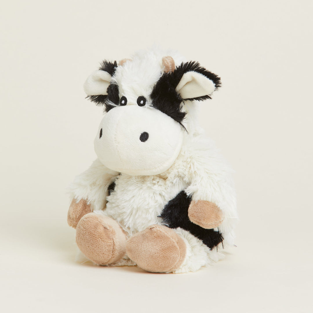 Warmies Junior cow plush toy in black and white with pink hooves