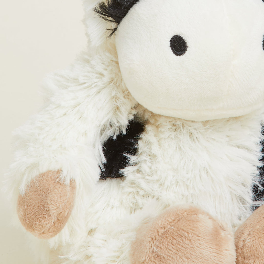 Warmies Junior plush cow stuffed animal with black and white spotted pattern
