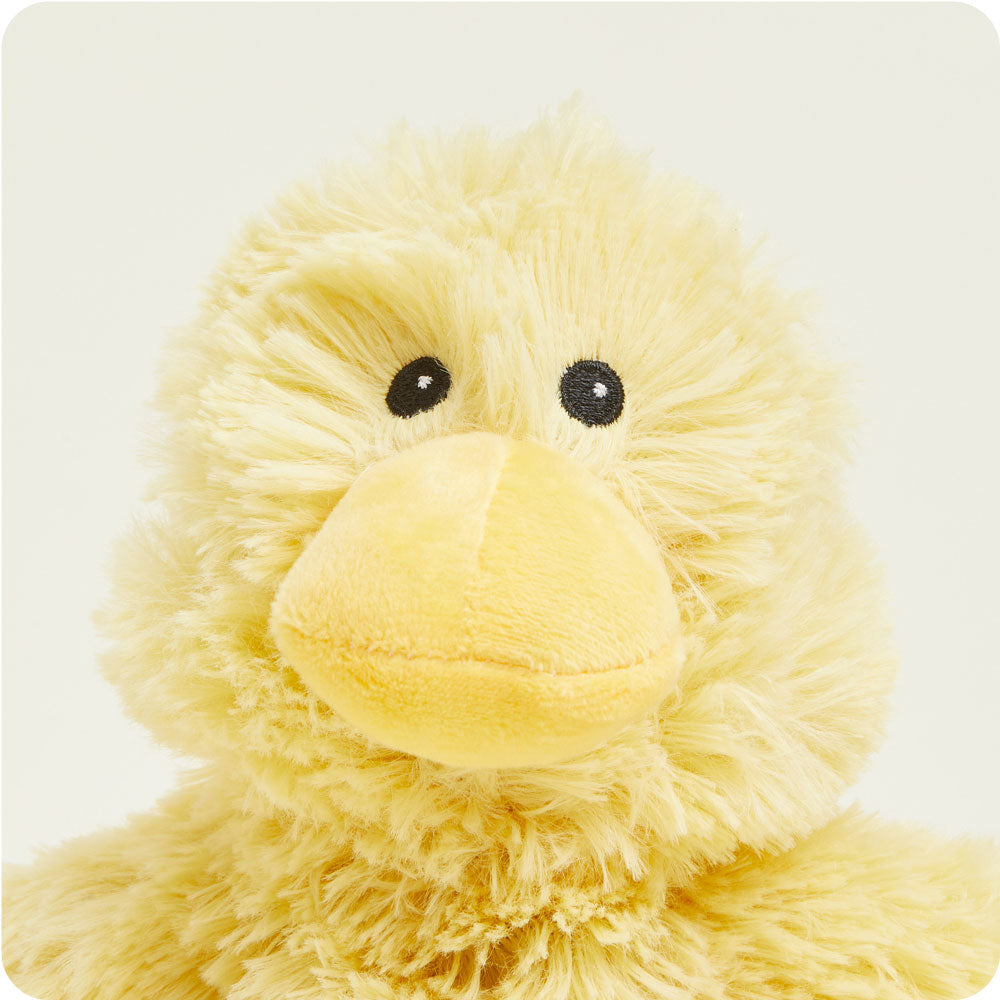Yellow fluffy Junior Warmies duck plush toy with black button eyes on white background