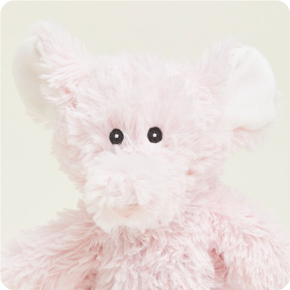 Pink fluffy elephant plush toy with black button eyes and soft fur texture