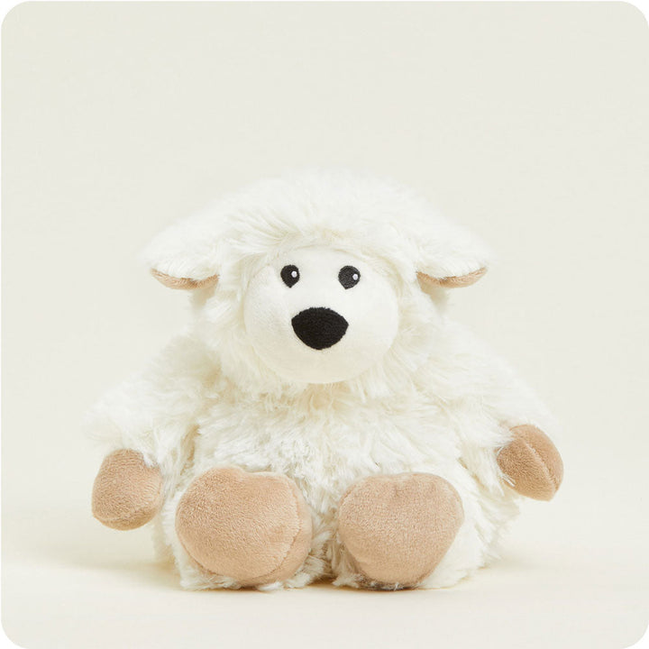 White fluffy sheep plush toy with tan hooves and black facial features