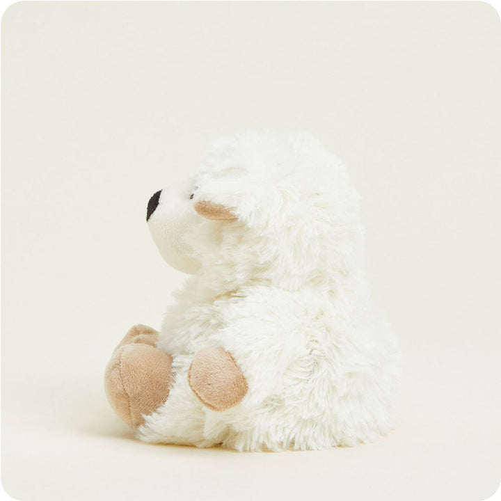 White fluffy sheep-shaped Warmies plush toy with tan hooves on white background