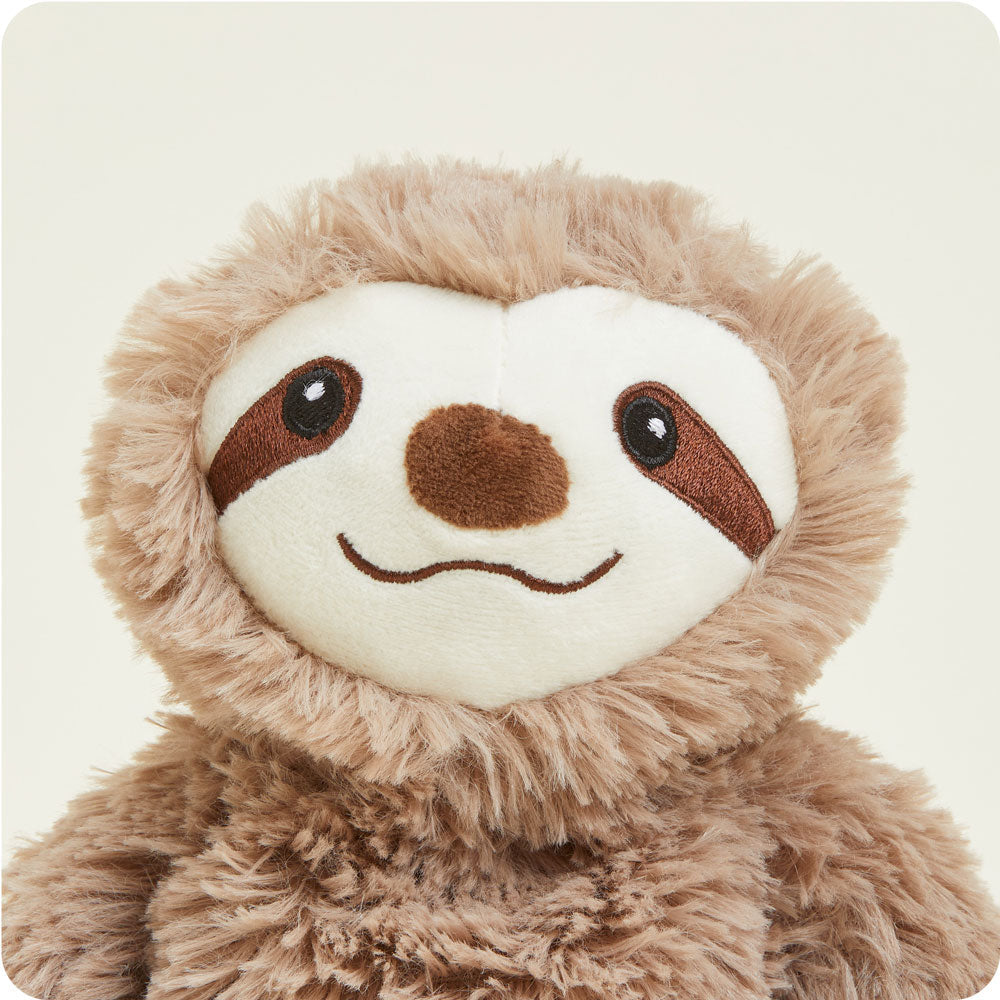 Warmies Junior plush sloth with brown fluffy fur and cream colored smiling face