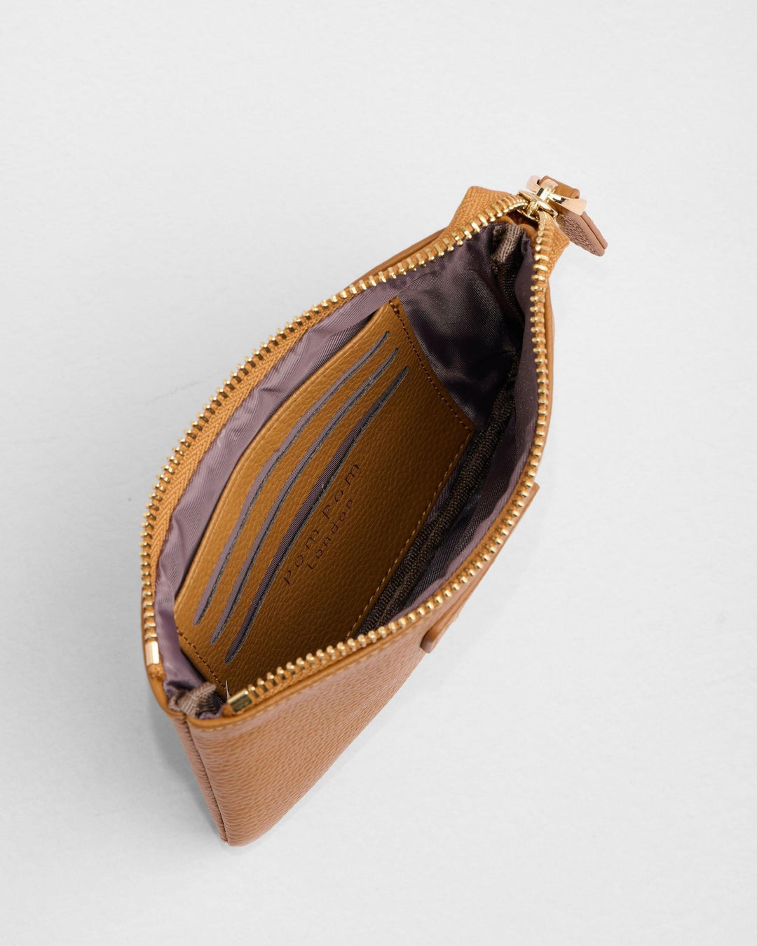 Open brown leather Chelsea coin purse showing interior card slots and zippered compartment
