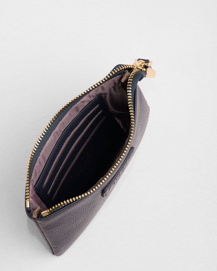Open dark purple leather coin purse with gold zipper showing card slots interior