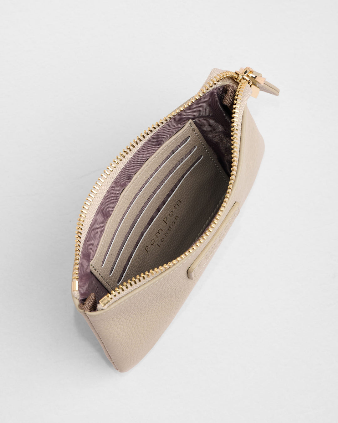 Stone beige leather coin purse with gold zipper showing interior card slots