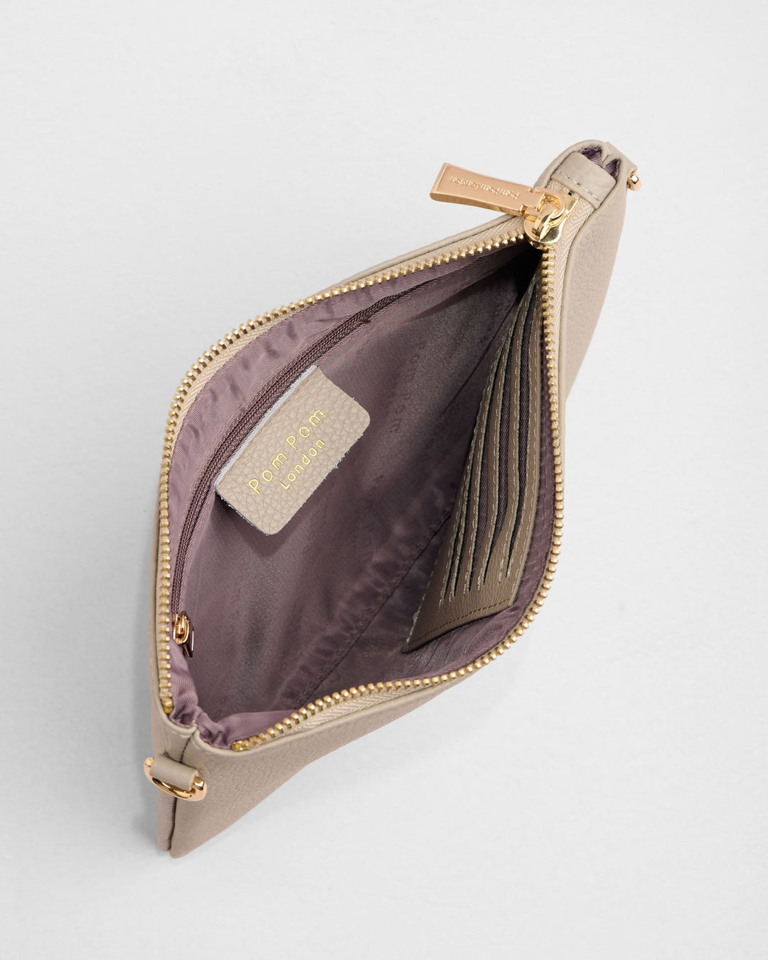 Open beige leather coin purse showing purple interior lining and card slots