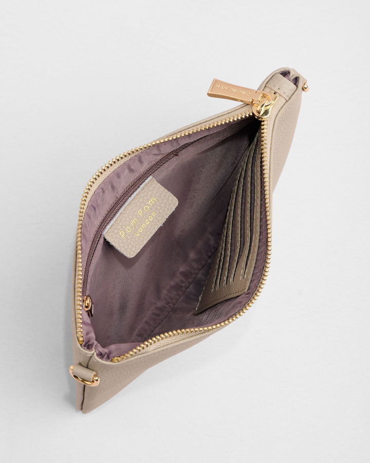 Open beige leather coin purse showing purple interior lining and card slots