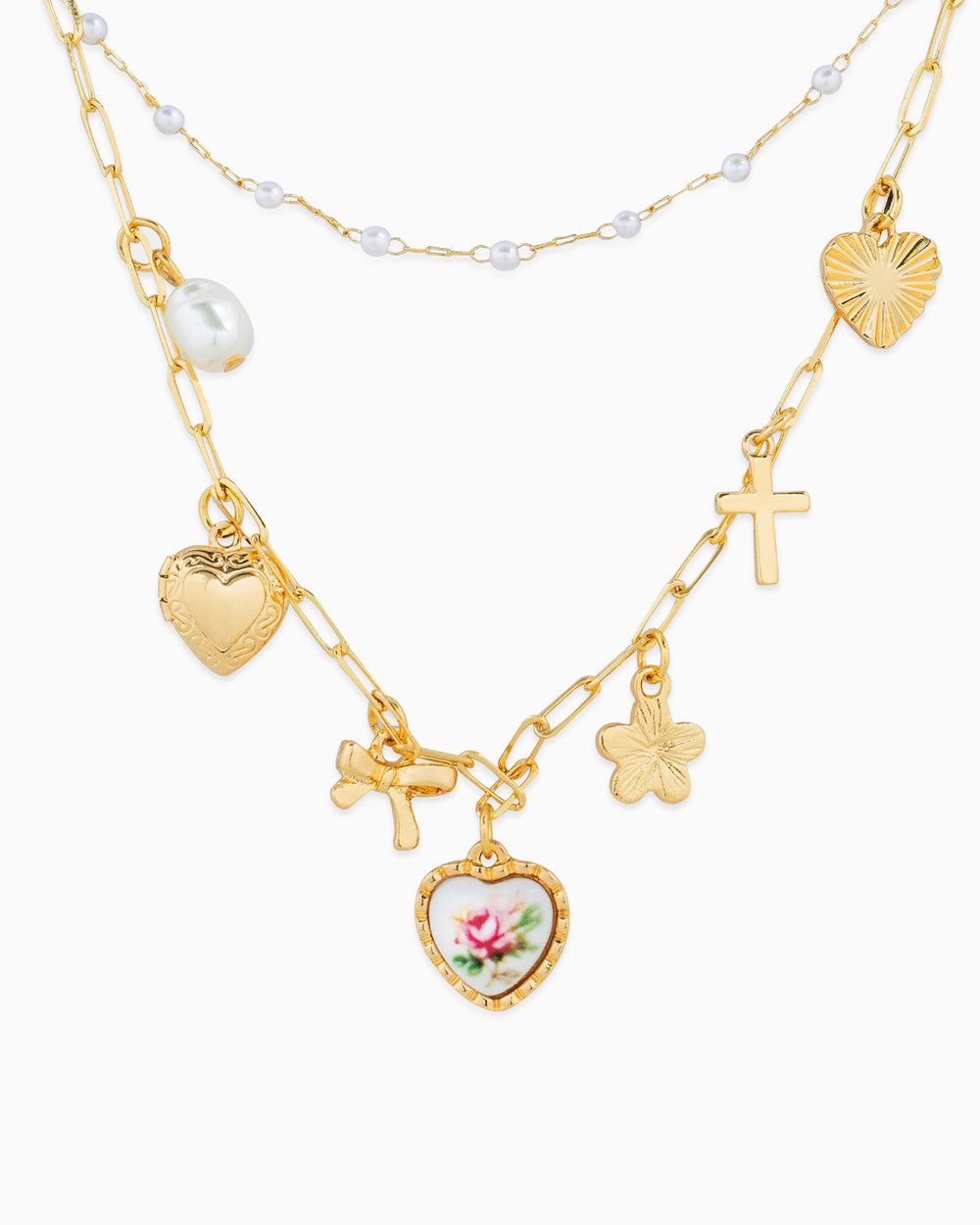 Gold layered charm necklace with pearl accents, hearts, cross, bow, and pink floral ceramic heart charm