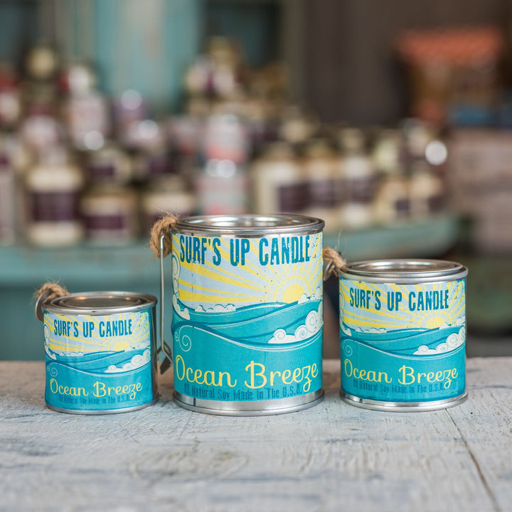 Surf's Up Candle Ocean Breeze paint can candles in three sizes on weathered wood surface