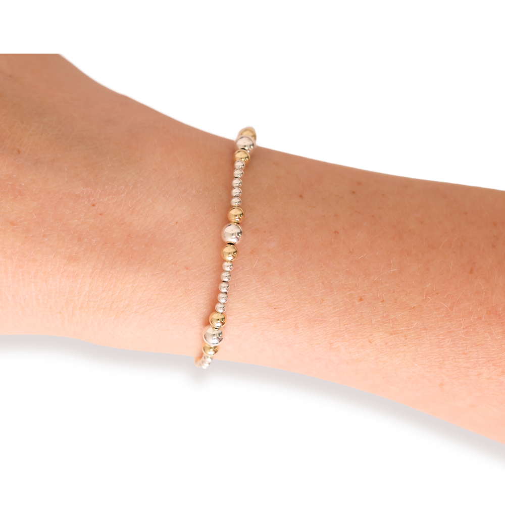 Dainty Sutton beaded bracelet in silver and gold worn on a wrist