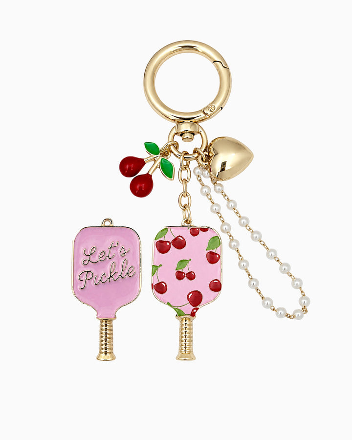 Pink pickleball paddle bag charm keychain with cherry print, pearls, and gold heart charm