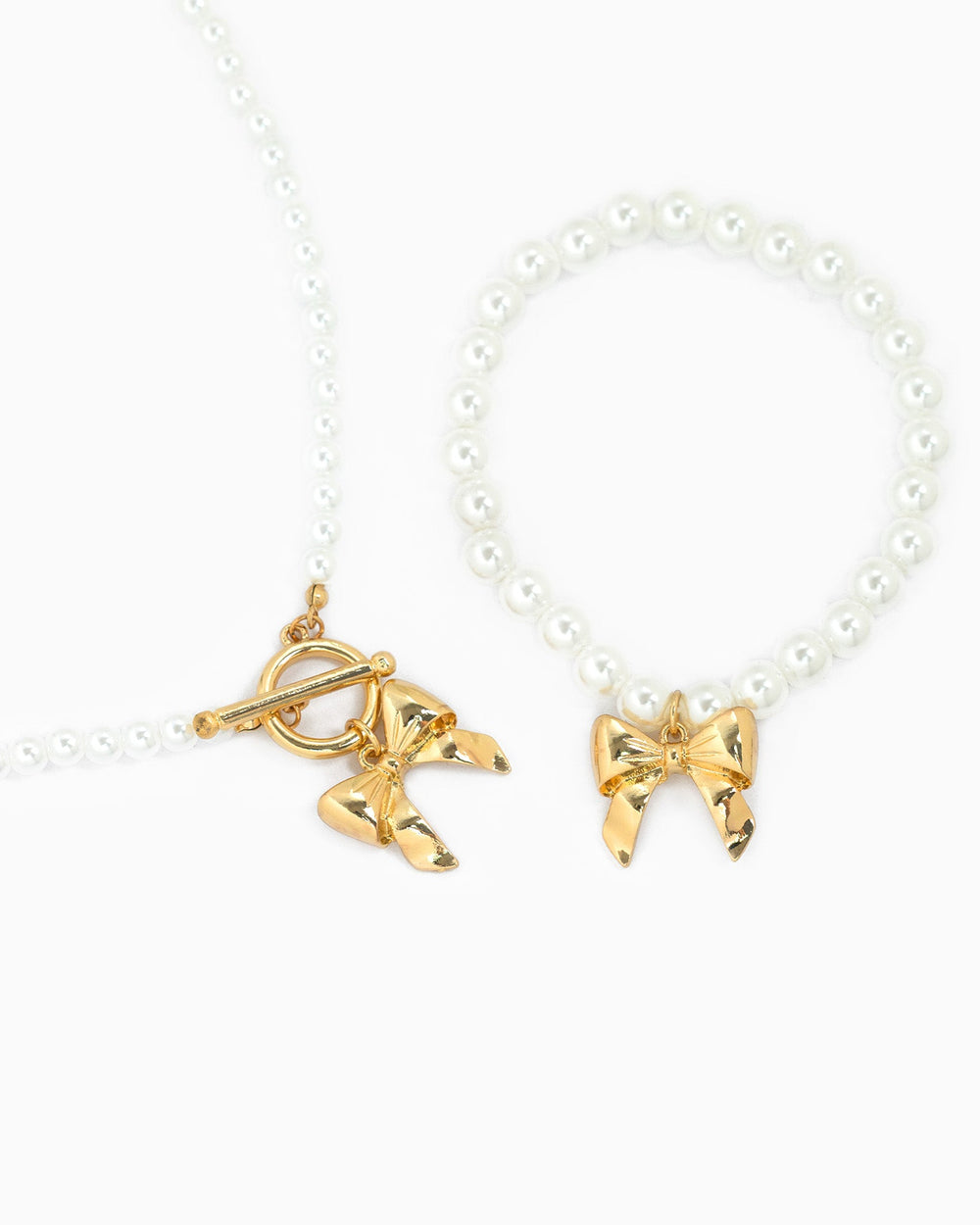 Sessori pearl necklace with gold bow pendant and toggle clasp, paired with matching bracelet