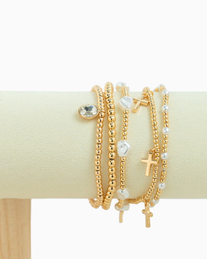 Set of 5 gold beaded stretch bracelets with cross charms, pearls, and crystal stone