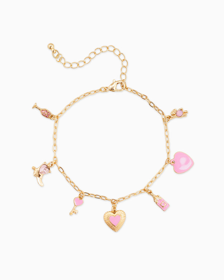 Gold charm bracelet with pink enamel hearts, key, and Valentine-themed charms on white background