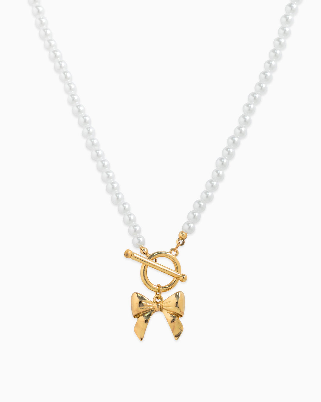 Sessori pearl beaded necklace with gold toggle clasp and gold bow pendant charm