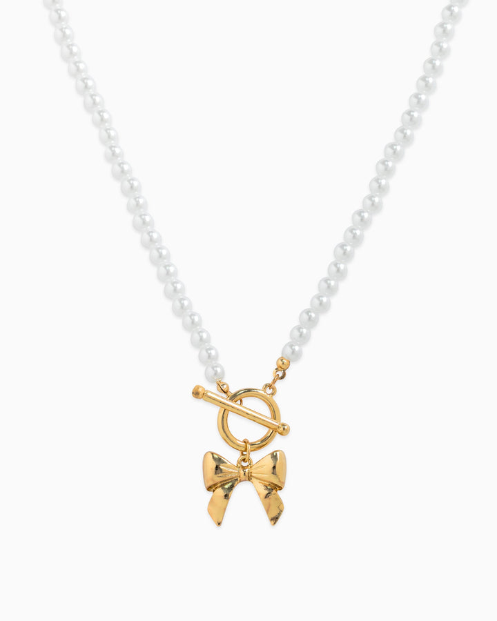 Sessori pearl beaded necklace with gold toggle clasp and gold bow pendant charm