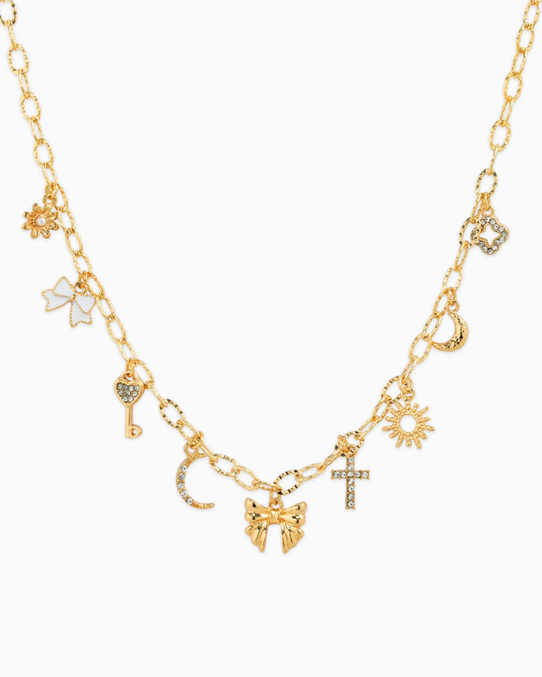 Gold multi-charm necklace featuring bow, sunburst, cross, moon, key, and floral charms