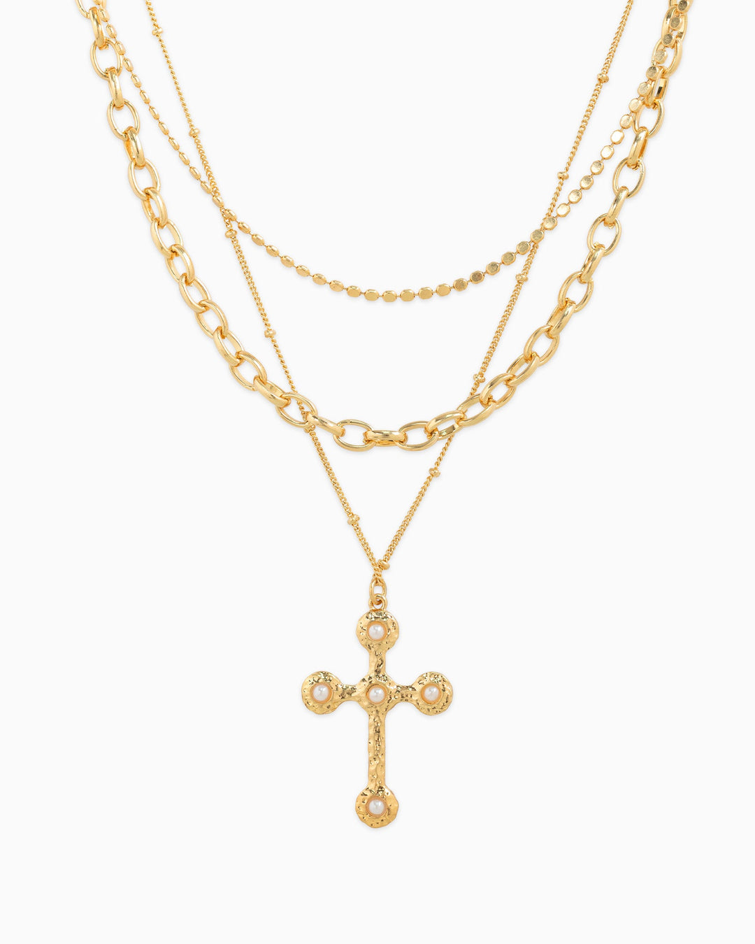 Three-layer gold necklace set featuring hammered cross pendant with pearl embellishments