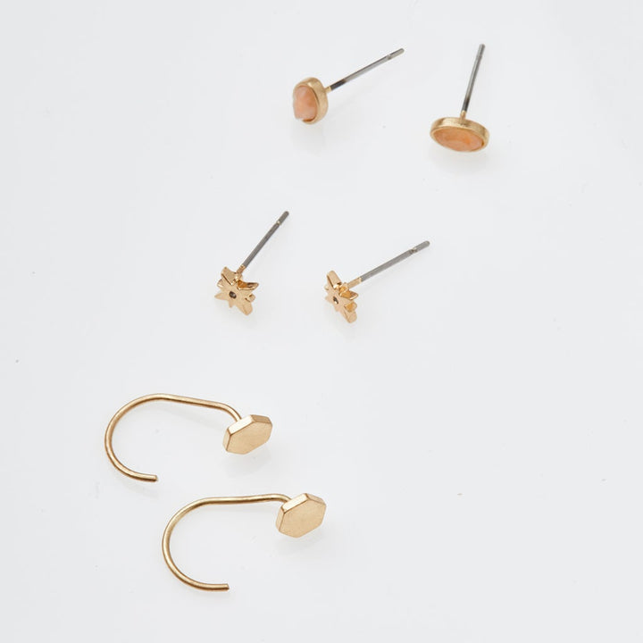 Scout Stud Trio earring set with gold circular studs, star studs, and curved ear cuffs