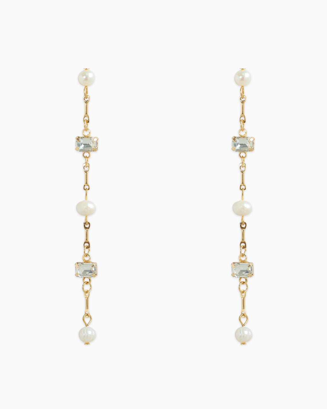 Gold linear drop earrings featuring freshwater pearls and pale baguette stones alternating on chain