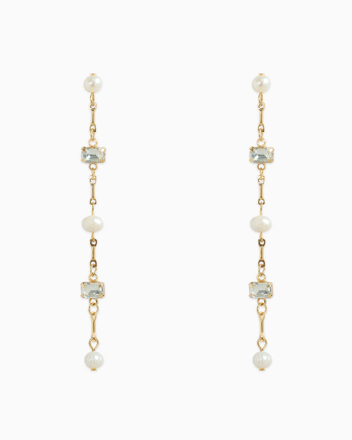 Gold linear drop earrings featuring freshwater pearls and pale baguette stones alternating on chain