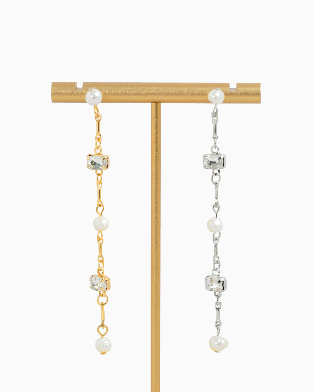 Sessori linear drop earrings featuring freshwater pearls and clear baguette crystals in gold and silver tones