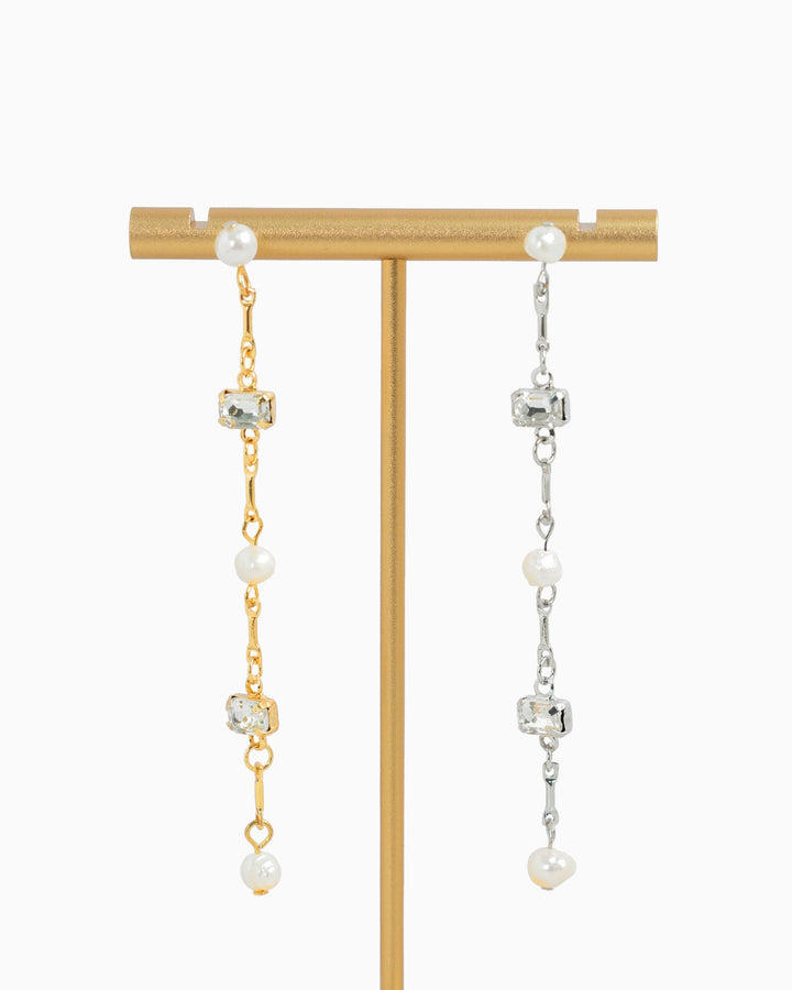 Sessori linear drop earrings featuring freshwater pearls and clear baguette crystals in gold and silver tones