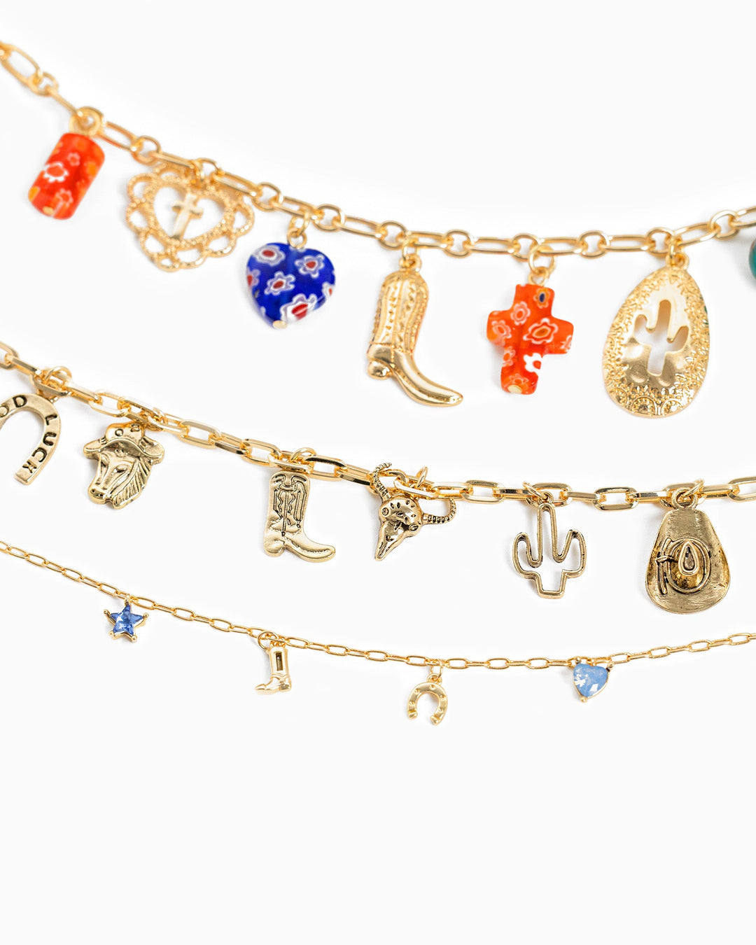 Layered gold western charm necklaces featuring cowboy boots, cactus, horseshoe, and colorful beads