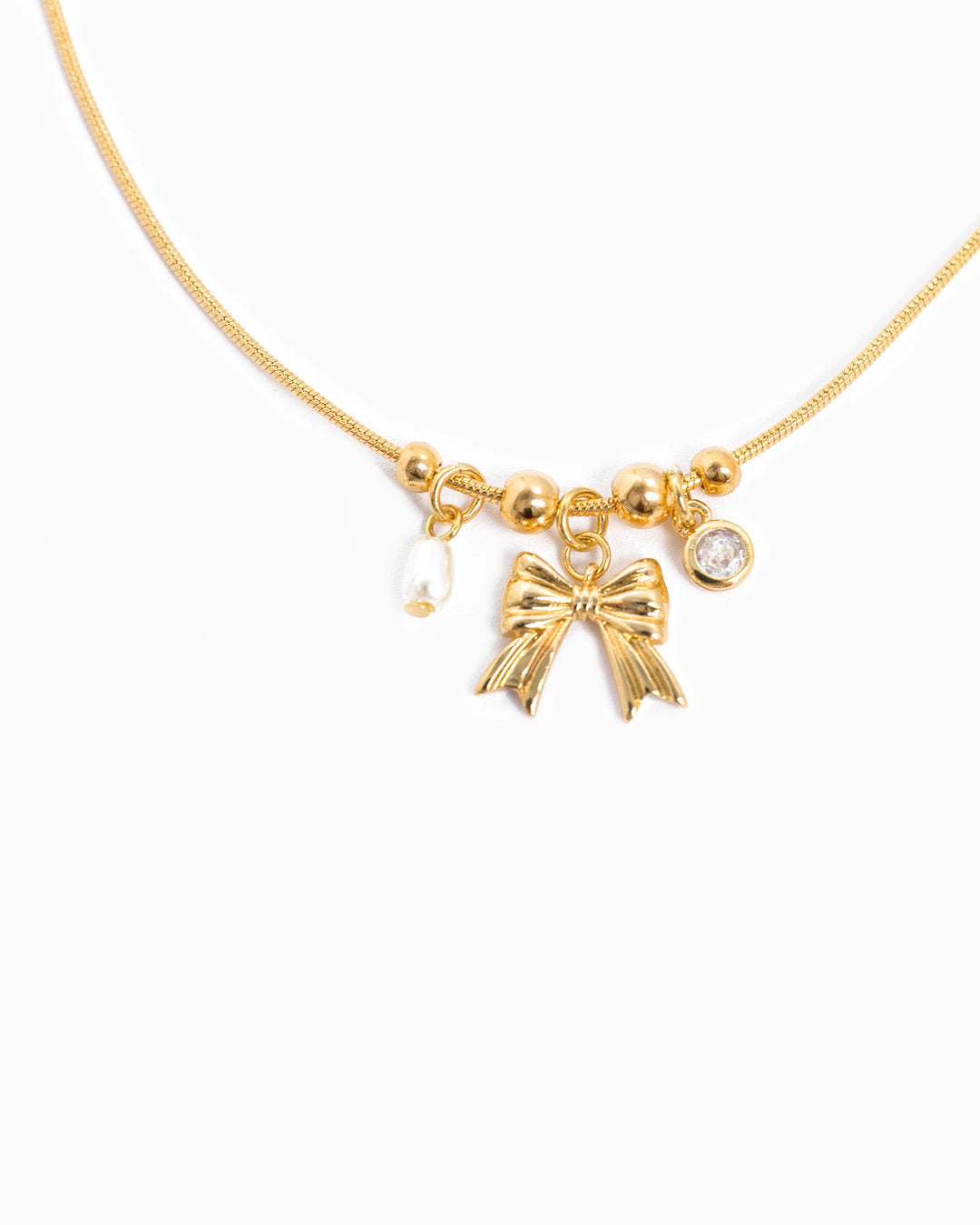 Sessori gold dainty necklace with bow charm, small pearl, and crystal pendant