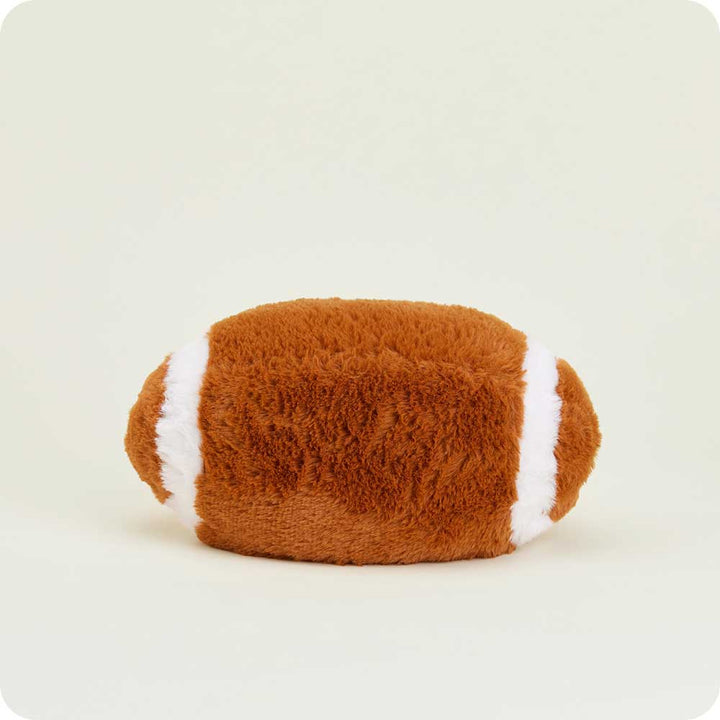 Warmies plush football-shaped heating pad in brown and white