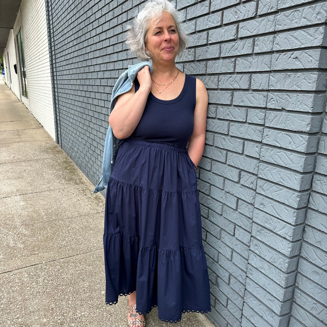 Sleeveless dress with tie waist and tiered bottom—true-to-size, feminine style made for confident women 30+.
