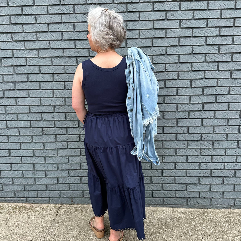 Sleeveless dress with tie waist and tiered bottom—true-to-size, feminine style made for confident women 30+.