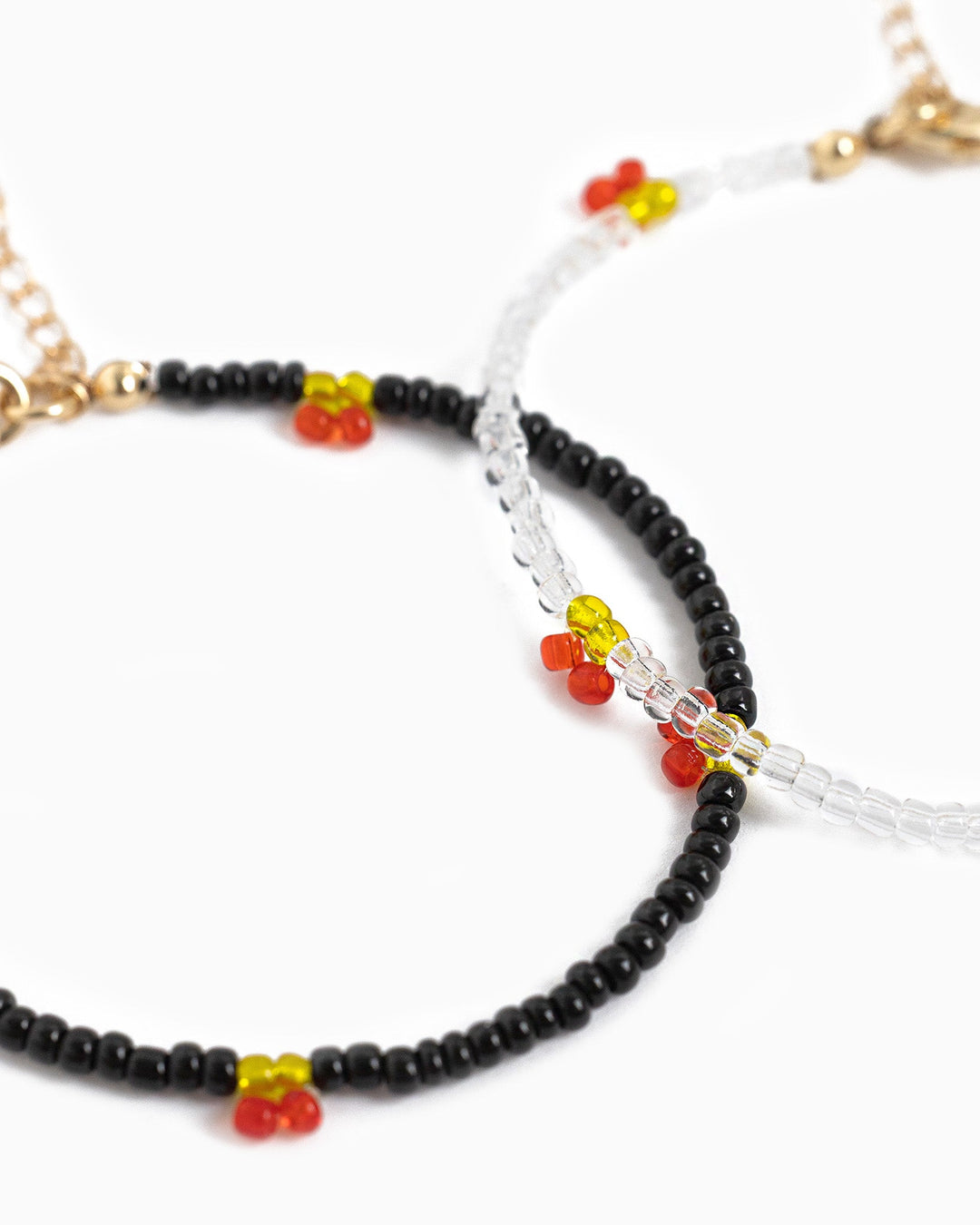 Sessori beaded bracelets with black and clear beads featuring red and yellow cherry charms