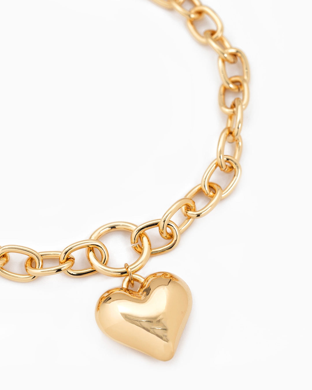 Gold chunky oval chain necklace with a large polished puffy heart charm pendant.