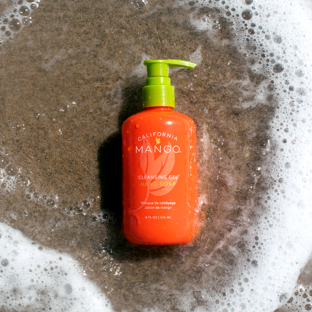 California Mango Cleansing Gel Hand Soap 8oz in orange pump bottle surrounded by soap suds