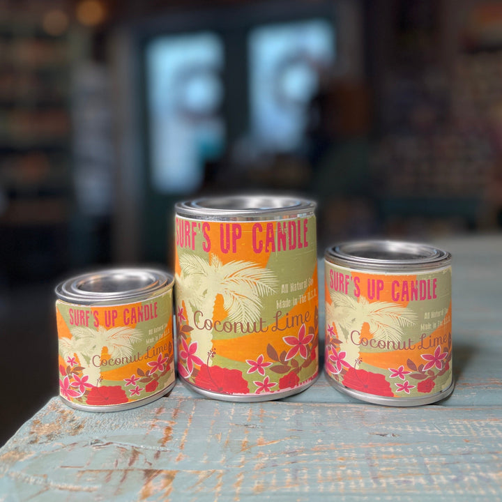 Three sizes of Surf's Up Candle Coconut Lime paint can candles with tropical floral label design.